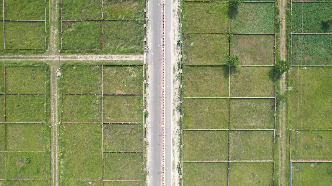contact-img Aerial shot of lush green fields and road in rural Dhaka, Bangladesh.