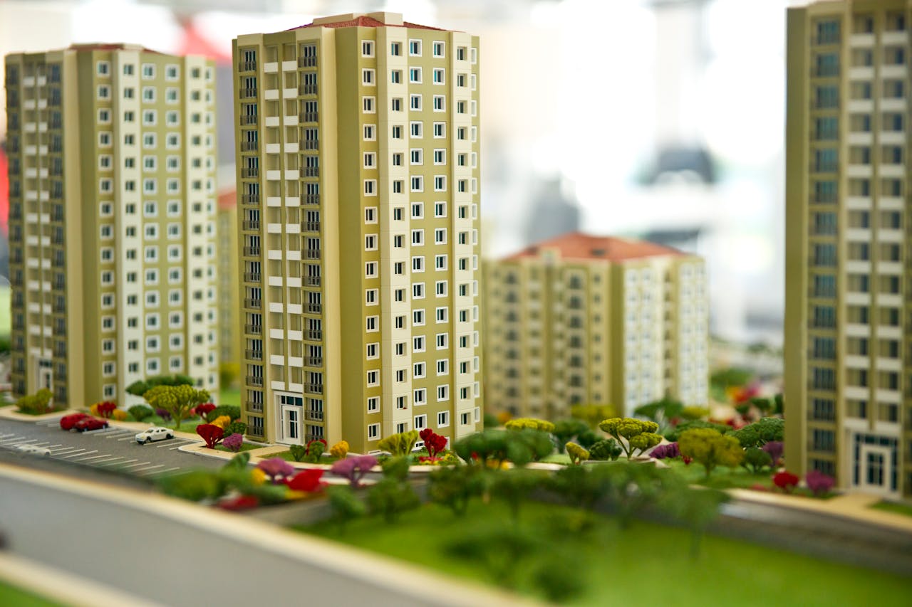 hero-img-01 Close-up image of a modern residential building model, showcasing urban architecture.